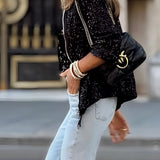 Women's sequin blazer with a glittery finish, ideal for street style evening wear. The jacket features a tailored fit with defined shoulders and long sleeves, suitable for pairing with jeans or evening attire.