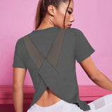 
A woman wearing a gray, slim-fit, crew neck T-shirt in XL size, showcasing a casual style. The T-shirt fits closely to her body, highlighting the neckline and shoulder area. Her hair and eyelashes are visible, adding to the overall look.