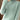 A close-up image of a women's green slim fit turtleneck sweater featuring ribbed cuffs, suitable for winter fashion.