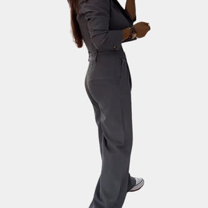 Women's slim fit gray business suit with a modern high-waisted design, featuring a blazer and knee-length dress, perfect for formal office wear.