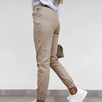 Women's slim fit olive green chinos with a high waist and tapered leg design in size XXL, displayed in a setting showcasing the trousers as the focal point.