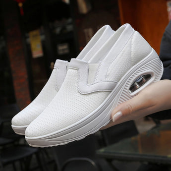 Light grey women's slip-on walking sneakers with a sporty design, featuring a lightweight and breathable material for enhanced comfort and arch support, suitable for outdoor activities.