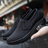 Black women's slip-on walking sneakers featuring a lightweight and breathable design with arch support.
