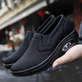 Black women's slip-on walking sneakers featuring a lightweight and breathable design with arch support.