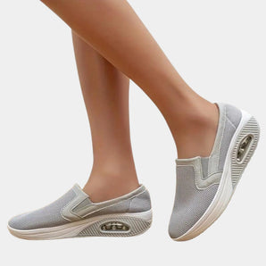 Women's slip-on walking sneakers with lightweight and breathable design, featuring arch support for comfortable wear.