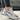 Gray women's sneakers with gold accents, designed in a trendy casual chic style, suitable for walking and sportswear.