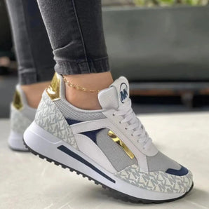 Gray women's sneakers with gold accents, designed in a trendy casual chic style, suitable for walking and sportswear.