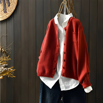 Red women's soft knit cardigan sweater in 3XL size, displayed on a clothes hanger. The sweater features long sleeves, a collar, and a fashionable design, ideal for outerwear.
