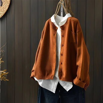 Women's 3XL orange soft knit cardigan sweater on a clothes hanger, showcasing its collar, sleeves, and fashion design details.