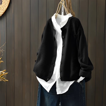 Women's black knit cardigan sweater in 3XL size, featuring long sleeves and a collar, hanging on a clothes hanger.