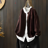 Brown women's soft knit cardigan sweater in size 3XL hanging on a clothes hanger, showcasing the full sleeves and collar design with a formal and elegant appearance.