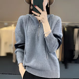 
A woman wearing a blue 2XL soft half-zip sweater with glasses. Her arm and shoulder are visible, showcasing the modern winter fashion design. The sweater features a long sleeve and a comfortable fit, suitable for stylish winter wear.