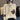 A woman's beige half-zip sweater in size 2XL, featuring a modern design with long sleeves and a soft texture, worn by a model showcasing the shoulders and neckline.