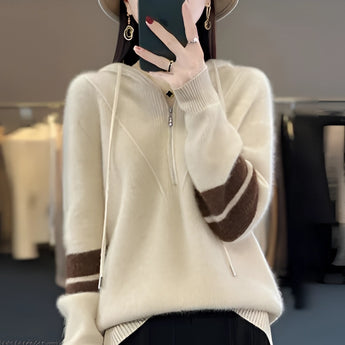 A woman's beige half-zip sweater in size 2XL, featuring a modern design with long sleeves and a soft texture, worn by a model showcasing the shoulders and neckline.