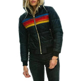 Women's striped color block puffer bomber jacket featuring a prominent collar and long sleeves, designed for insulated winter wear with a stylish fashion design.