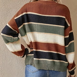 Women's multicolor striped crew neck sweater with long sleeves, styled with jeans, showcasing fall fashion knitwear.