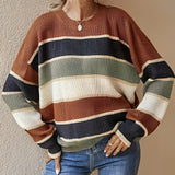 Women's multicolor striped crew neck sweater featuring long sleeves and a cozy knit design, paired with jeans.