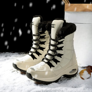 Women's stylish waterproof insulated fur-lined winter boots on a snowy surface.
