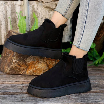 White platform high-top slip-on sneakers for women displayed outdoors, showcasing a stylish fashion design.