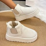 Women's stylish white platform high-top slip-on sneakers on a grey floor surface.