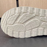 Women's stylish white platform high-top slip-on sneakers with a sleek design, featuring a chunky sole and minimalist aesthetic, placed against a neutral background.