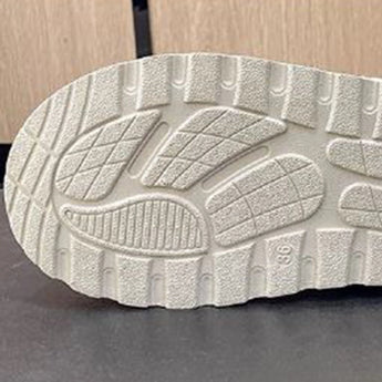 Women's stylish white platform high-top slip-on sneakers with a sleek design, featuring a chunky sole and minimalist aesthetic, placed against a neutral background.