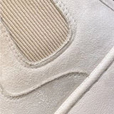 White platform high-top slip-on sneakers for women with a stylish design, featuring a patterned upper and a sleek, sporty appearance.