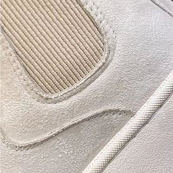 White platform high-top slip-on sneakers for women with a stylish design, featuring a patterned upper and a sleek, sporty appearance.