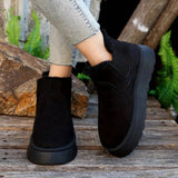 White platform high-top slip-on sneakers worn by a person standing on grass.