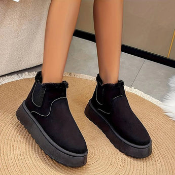 
A pair of women's stylish white platform high-top slip-on sneakers shown on a model standing, highlighting the black variant in size 40.5.
