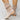 Women's apricot suede ankle boots with a buckle strap and zipper, featuring a low heel design.