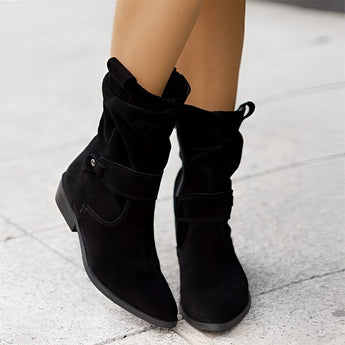 Black women's suede ankle boots featuring a buckle strap and side zipper, designed with a low heel and stylish fashion elements.