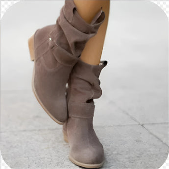 Women's dark gray suede ankle boots featuring a buckle strap and zipper with a low heel, displayed against a neutral background.