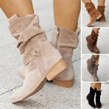 Women's beige suede ankle boots featuring a buckle strap and zipper with a low heel, styled with fashion-forward design elements.