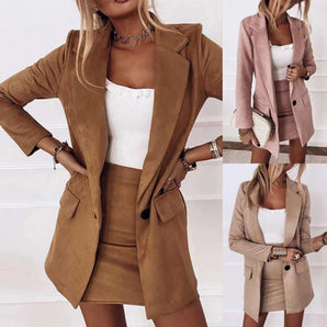 
A woman's brown suede blazer displayed on a hanger, showcasing tailored design with structured shoulders and a classic notch lapel, emphasizing its versatile chic and business attire style.
