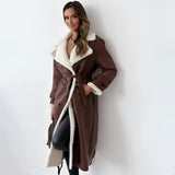 Women's tan double-breasted shearling trench coat in size XL, featuring a classic overcoat design with a notched collar, long sleeves, and a fitted waist. The coat falls to knee length, showcasing a stylish and fashionable design suitable for colder weather.