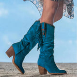 
Women's tan fringe suede boots with a blue mid-calf design, showcasing western boho fashion elements.