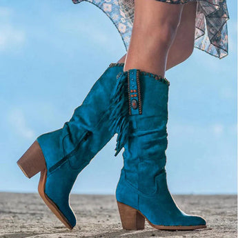 
Women's tan fringe suede boots with a blue mid-calf design, showcasing western boho fashion elements.