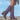 Tan suede mid-calf boots with fringe detailing, shown in a western boho style, featuring a purple background.