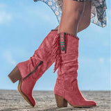 Women's mid-calf tan suede fringe boots with a Western Boho style, featuring a slight heel, worn by a person outdoors.