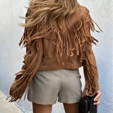 Women's tan fringed suede jacket featuring a boho chic design, with a focus on the shoulder and sleeve detailing, showcasing the natural material in a light beige color.