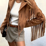 Women's tan fringed suede jacket with boho chic design, featuring long sleeves, a collared neckline, and waist-length cut, displayed against a neutral background.