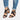 Women's black chunky heel sandals with strappy design and buckle strap, shown on a model wearing jeans.