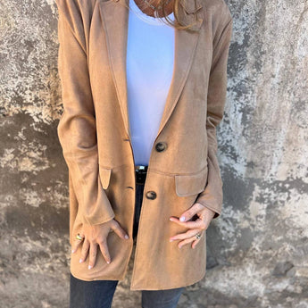 Tan suede blazer for women with a lightweight design, suitable for fall fashion. The jacket features a beige color, long sleeves, and a tailored fit at the waist.