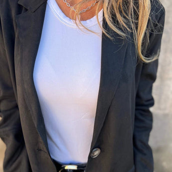 Women's tan suede blazer, lightweight and perfect for fall fashion, featuring long sleeves and a tailored fit, worn over a white dress shirt.