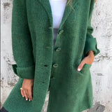 Women's green wool coat with an elegant notch collar and long sleeves, designed in a blazer style.