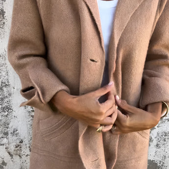 Elegant women's tan wool coat in a camel color, featuring a notch collar, long sleeves, and a tailored fit. The coat is styled over a dress shirt, accentuating the neck and waist areas. Available in Cachi color and 5XL size.