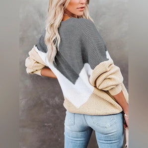 Women's oversized sweater in a tri-color design, showcasing cozy fall knitwear with long sleeves and a relaxed fit. The sweater's color palette includes shades of grey.