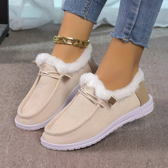Women's turquoise fur-lined slip-on shoes, featuring a cozy and stylish design perfect for winter, displayed against a neutral background.
