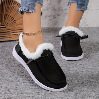 Women's turquoise fur-lined slip-on shoes displayed against a white background, showcasing stylish winter footwear design with black and blue elements.